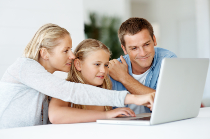 girl on computer with parents